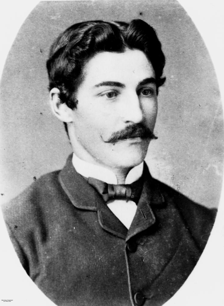 a black and white photo of a man with a moustache